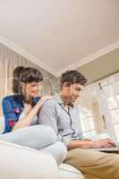 Young couple using a laptop