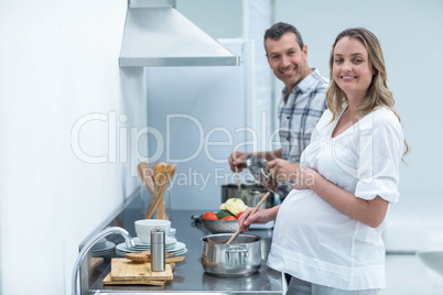 Pregnant couple in kitchen