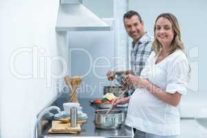 Pregnant couple in kitchen