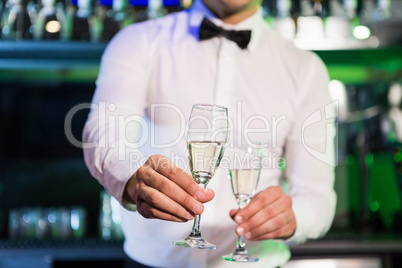 Bartender serving glass of champagne