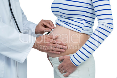 Doctor examining pregnant woman