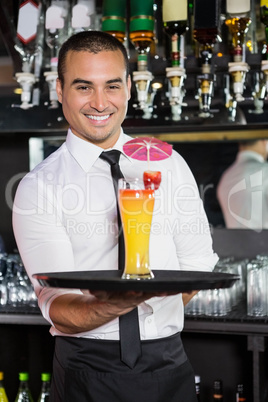 Portrait of bartender serving cocktail