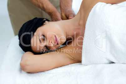 Pregnant woman receiving a back massage from masseur