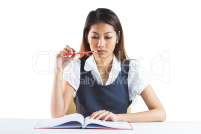 Thoughtful businesswoman reading