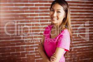 Smiling asian woman crossing arms
