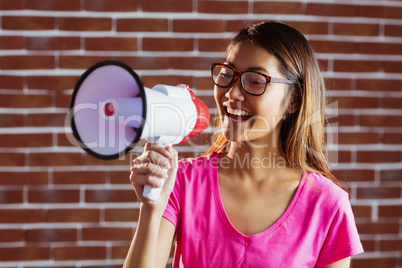 Asian woman shouting in megaphone
