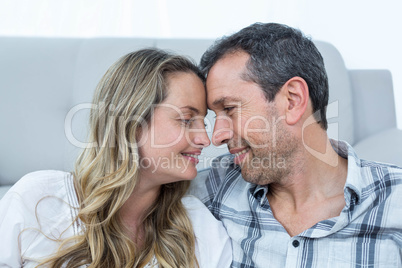 Pregnant couple sitting floor