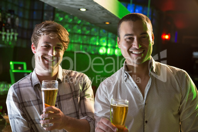 Portrait of two men having beer at bar