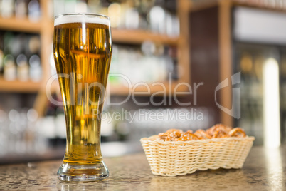 View of a pint of beer and pretzels