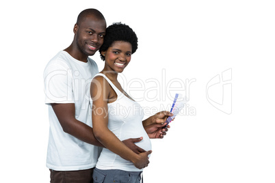Pregnant couple holding color swatches