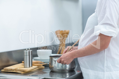 Pregnant woman busy in kitchen