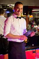 Portrait of waiter standing with a menu card