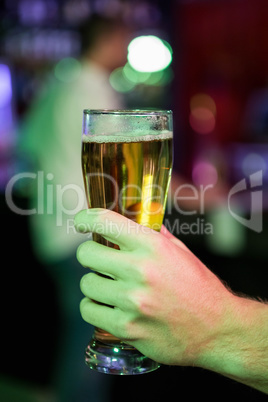 Close-up of man holding glass of beer