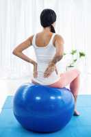 Pregnant woman exercising on exercise ball