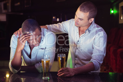 Man comforting his depressed friend