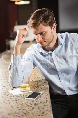 Tired man leaning his elbow on the counter