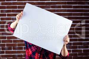 Pretty blonde woman holding a white sign