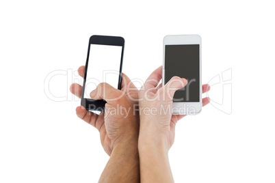 Hands of a couple holding smartphones