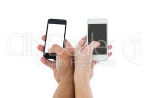 Hands of a couple holding smartphones