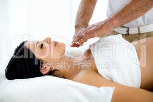 Pregnant woman receiving a spa treatment from masseur