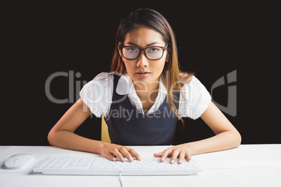 Serious businesswoman using a computer