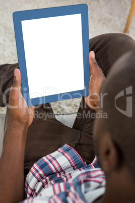 Man using digital tablet in kitchen