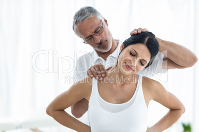 Doctor giving physiotherapy to pregnant woman