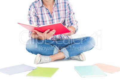 Man reading a book while sitting on the floor