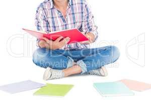 Man reading a book while sitting on the floor