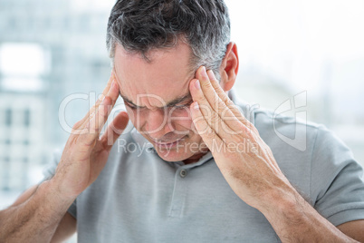 Tensed man touching his temples