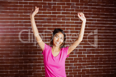 Smiling asian woman raising arms