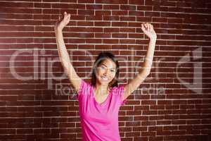 Smiling asian woman raising arms