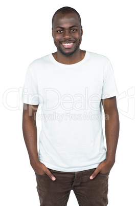 Happy man looking at camera with hands in pocket
