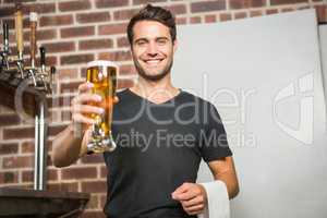 Handsome man holding a pint of beer