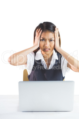 Nervous businesswoman using a laptop