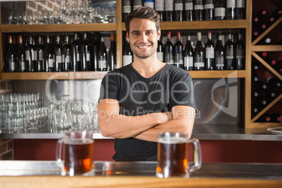 Handsome bar tender standing behind his counter