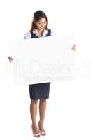 Smiling businesswoman holding a white poster