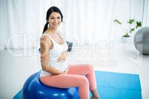 Pregnant woman exercising on exercise ball