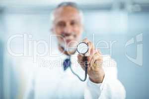 Happy doctor holding stethoscope