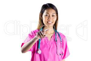 Asian nurse with stethoscope pointing in front of her