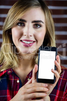 Pretty blonde woman showing smartphone screen