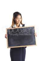 Smiling businesswoman holding a blackboard