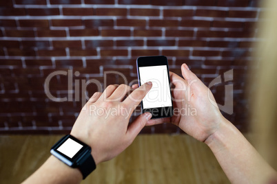 Feminine hands using smartphone and smart watch