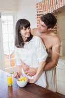 Young couple embracing while having breakfast