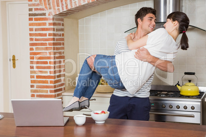 Man lifting woman in his arms