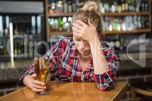 Exhausted woman having a beer