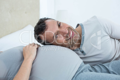 Man listening the belly of pregnant woman