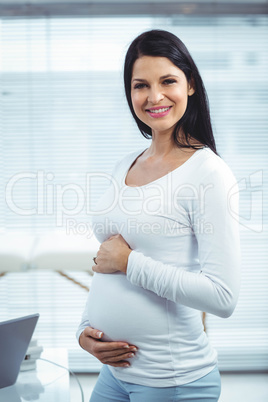 Pregnant woman holding her stomach