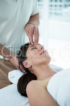 Pregnant woman receiving a massage from masseur