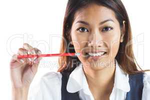 Smiling businesswoman holding a pencil